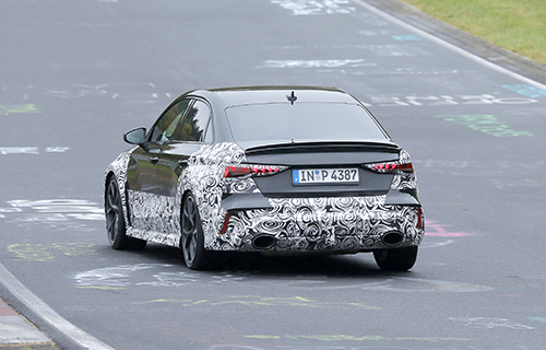 Rear of a camouflaged Audi RS3 on track