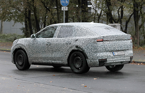 The Ford EV Crossover driving in camouflage in Europe.
